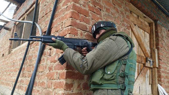 Security forces during search operation at Parigam in Pulwama district on Saturday. - Excelsior/Younis Khaliq