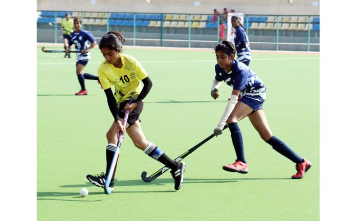 Girls in action during a hockey match at K K Hakku Stadium, Jammu on Saturday. —Excelsior/Rakesh