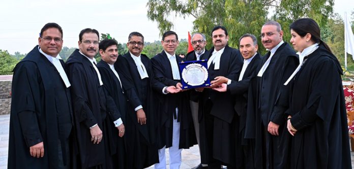 Chief Justice and other Judges of J&K and Ladakh HC presenting memento to Justice Mohan Lal at Jammu on Saturday.