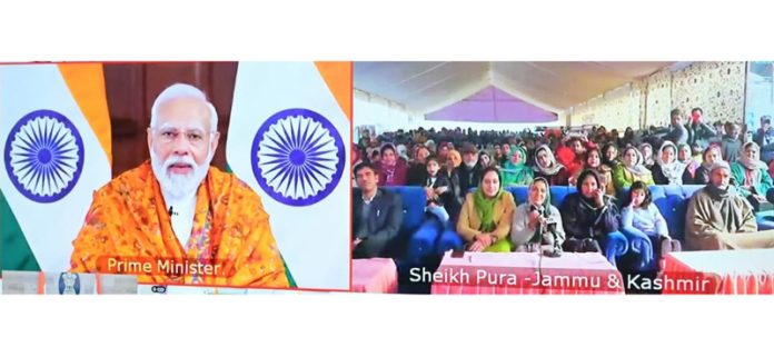 PM Narendra Modi interacting with a woman at Sheikhpora in Kashmir on Saturday.