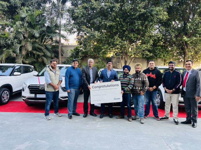 Chairman AM Group Jatinder Gupta along with others handing over a fleet of cars to corporate entity in Jammu on Saturday.