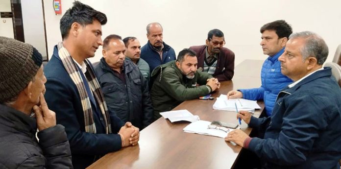 BJP leaders Ashwani Sharma and Puneet Mahajan listening public grievances at Jammu on Saturday.