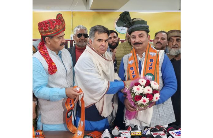 BJP UT president, Ravinder Raina and MP, Jugal Kishore Sharma taking former MLC, Mohammad Rafiq Shah into party fold at Jammu on Saturday.