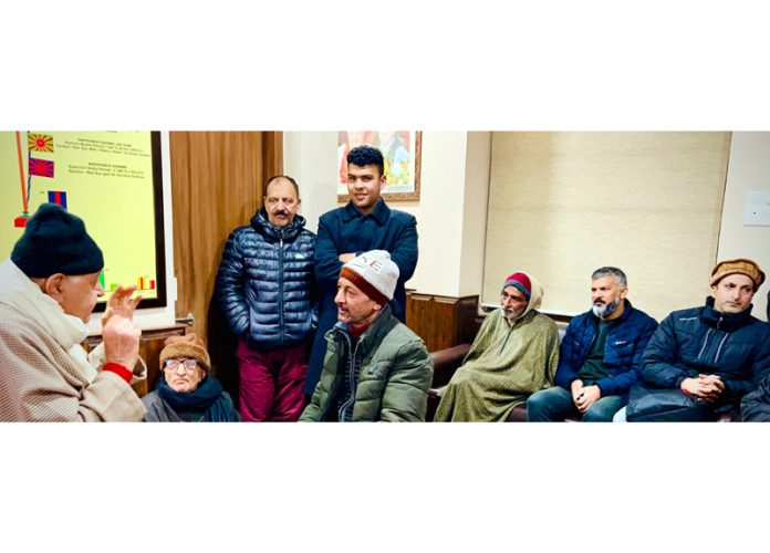 Farooq Abdullah listening to NC functionaries at party office in Srinagar.