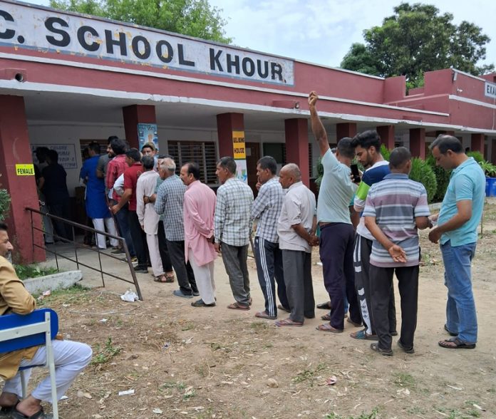 People line up for voting at a Polling Station in border village of Khour in Akhnoor sector.