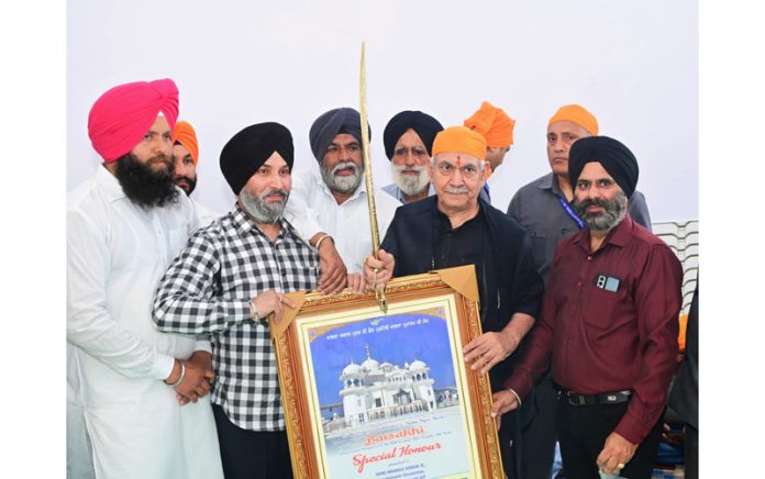 Lt Governor Manoj Sinha being presented a portrait of Gurudwara during Baisakhi celebrations at Ramgarh on Saturday.