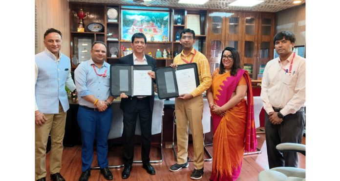 Anshul Garg and others displaying copies of MoU.