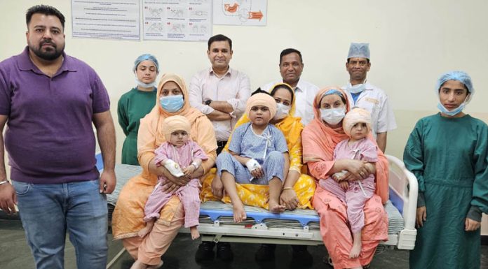 A team of doctors and other staff of SMVDNSH Kakryal posing with children on whom they performed Cochlear Implant Surgery.