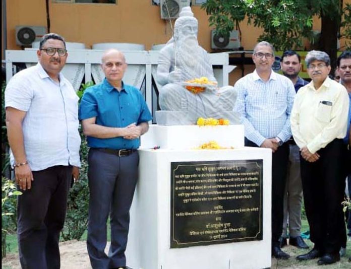 Principal, GMC Jammu Dr Ashutosh Gupta and others posing alongside statue of Maharishi Sushruta in College premises.