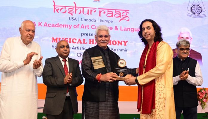 LG Manoj Sinha felicitating an artist in Srinagar on Saturday.