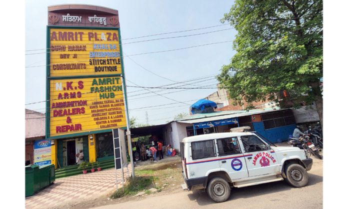 A police vehicle parked outside the residence of accused in fake gun license case at Karanbagh area during the raid. - Excelsior/Rakesh