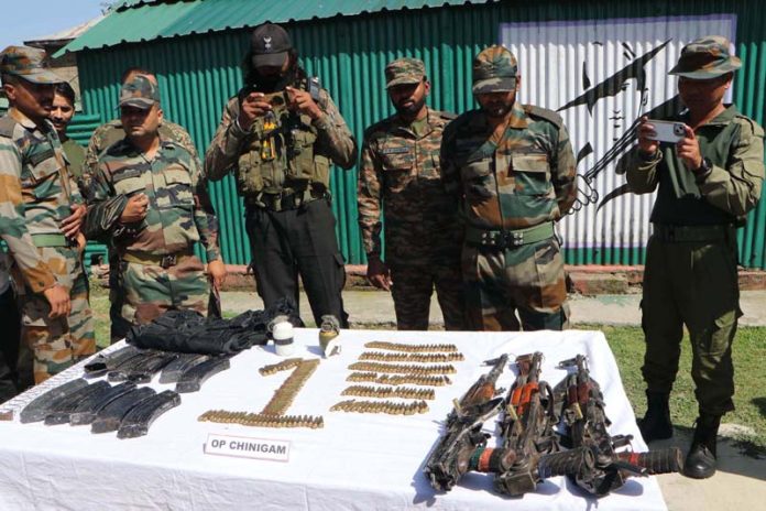 Security forces displaying arms and ammunition recovered from the militants at the two encounter sites in South Kashmir’s Kulgam district.