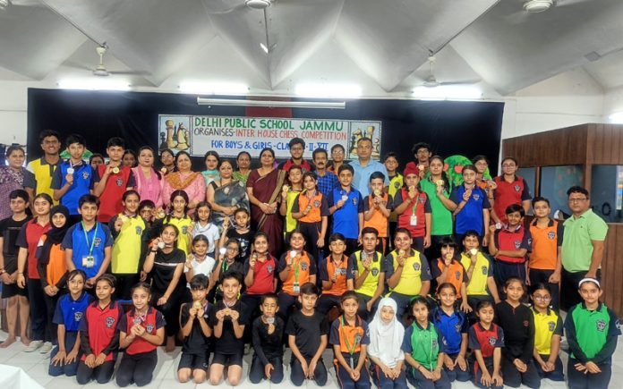 Students of DPS Jammu posing along with medals and school management during inter house competitions.