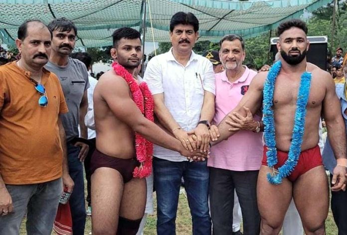 Guests posing with wrestlers during annual Korga Dangal at Katra in Reasi district.