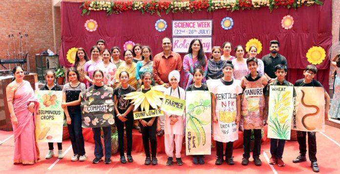 Students of Heritage posing in different dresses during a science event at school.