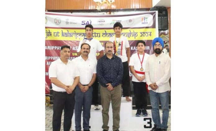 Guests posing with medal winners during J&K UT Kalaripayattu Championship at Baby Caterers Hall, Rehari in Jammu.