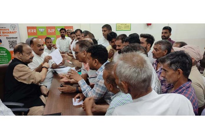 Senior BJP leader, Devender Singh Rana listening public grievances at BJP headquarters on Friday.