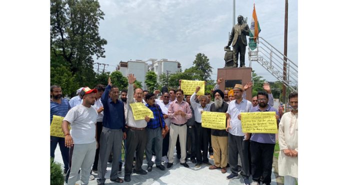 People protesting in Jammu against alleged displacement of statues of Gandhi, Ambedkar from Parliament premises in Delhi.