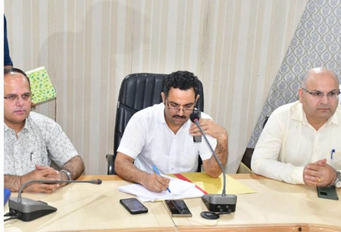 DC Rajouri listening grievances on phone call.