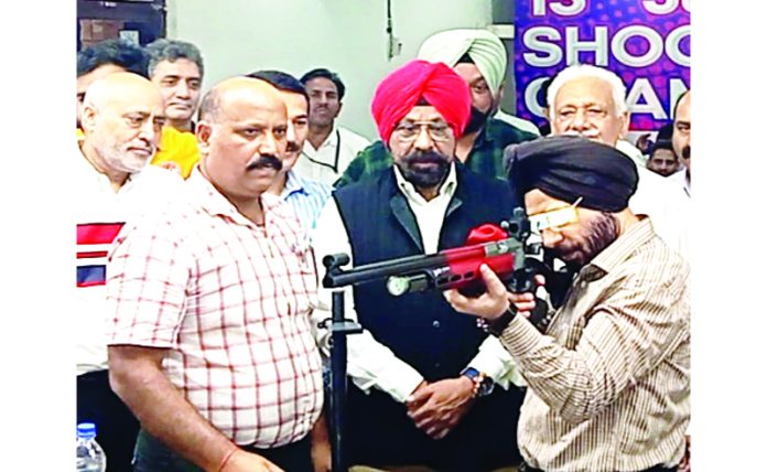 Director of Youth Services and Sports, Rajinder Singh Tara aiming at target during inaugural event of 13th J&K-UT Shooting Championship at Jammu.