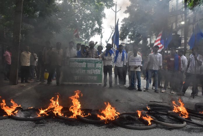 Bandh supporters burn tyres to block the road and raise slogans at a protest rally in Ranchi on Wednesday. (UNI)