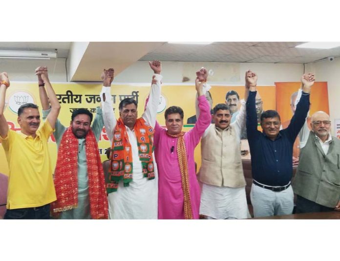 Former MLC, Murtaza Khan posing with Union Minister, G K Reddy and senior BJP leaders after joining the party at BJP Headquarters, Trikuta Nagar on Thursday.