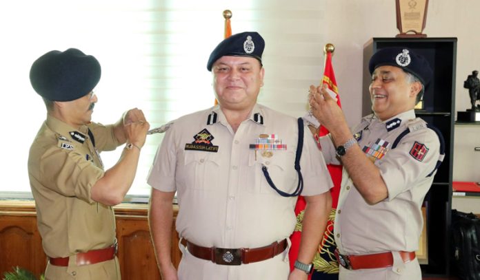 DGP RR Swain pinning rank to DIG Mubassir Latifi in Srinagar on Thursday.