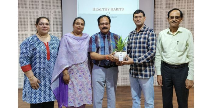 MIER College management presenting plant to chief guest during a programme.