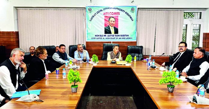 Justice Tashi Rabstan chairing a meeting at Kishtwar.