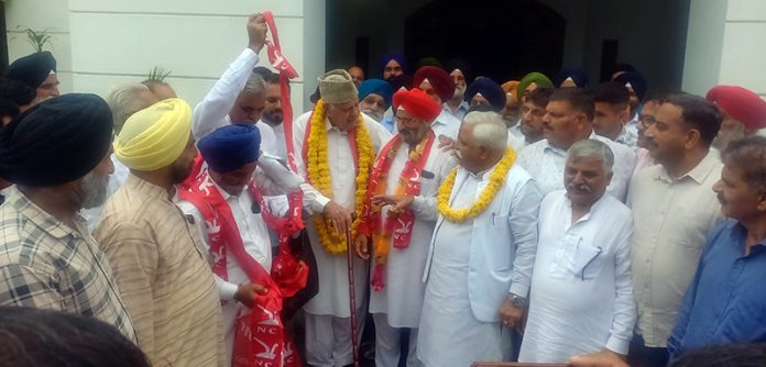 Dr Farooq Abdullah welcoming the new entrants into the NC fold at his residence in Jammu on Saturday.