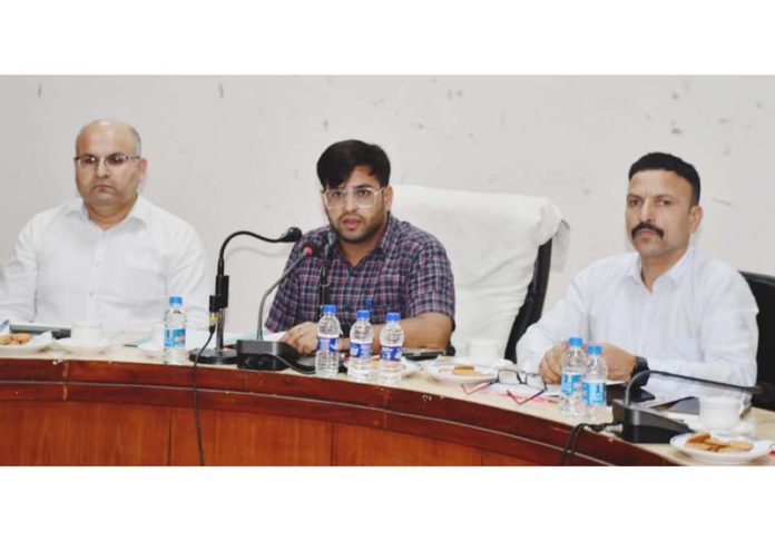 DEO Rajouri Abhishek Sharma chairing a meeting.