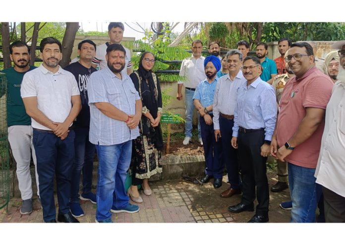 Transport Commissioner and others posing for a group photograph during plantation drive.