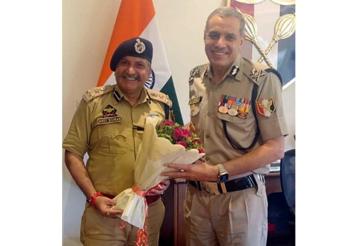 DIG JSK Range, Shiv Kumar Sharma, presenting a flower bouquet to IG BSF Jammu Frontier, DK Boora, in Jammu on Monday.