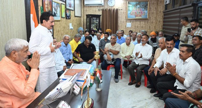 Delegations meeting with Sham Lal Sharma at his residence on Thursday.