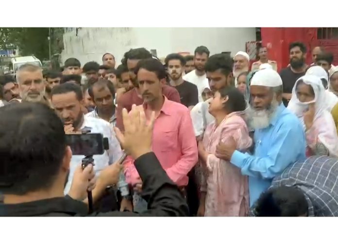 People protest outside Surankote police station on Sunday.