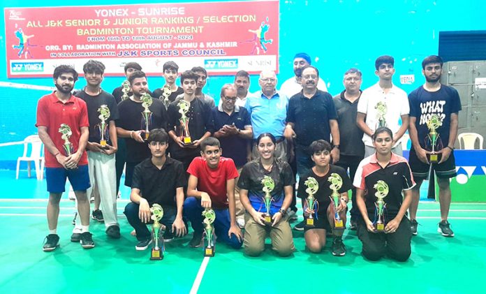 Winners posing along with trophies during the Badminton tournament.