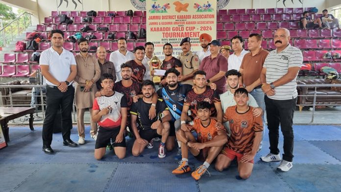 Dignitaries posing along with the winning team at MA Stadium Jammu.