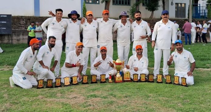 Sharda Cricket Club team posing along with trophy.