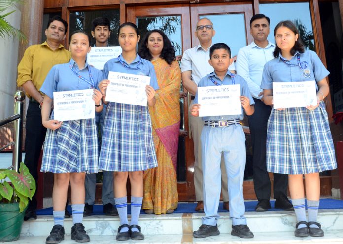 Students of KCPS posing along with certificates and school management.