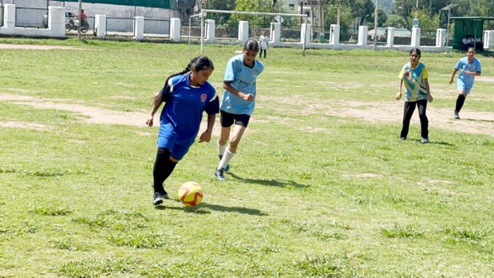 Young girls in action during a football match at Poonch.