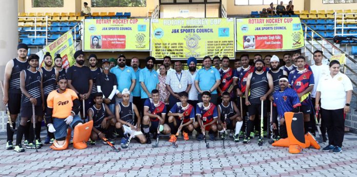 Hockey teams posing for group photograph along with dignitaries at Hakku Stadium, Jammu.