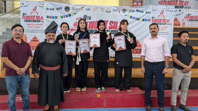 Pencak Silat team posing along with medals and certificaes at Leh.