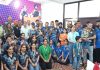 Medal winners posing along with guests after prize distribution ceremony.