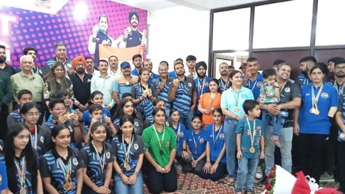 Medal winners posing along with guests after prize distribution ceremony.