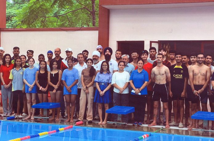 Swimmers posing along with dignitaries during selection trials at Jammu.