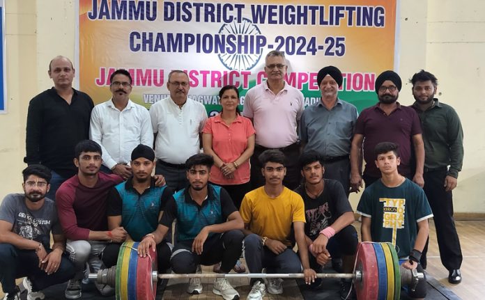 Weightlifters posing along with dignitaries during opening ceremony.