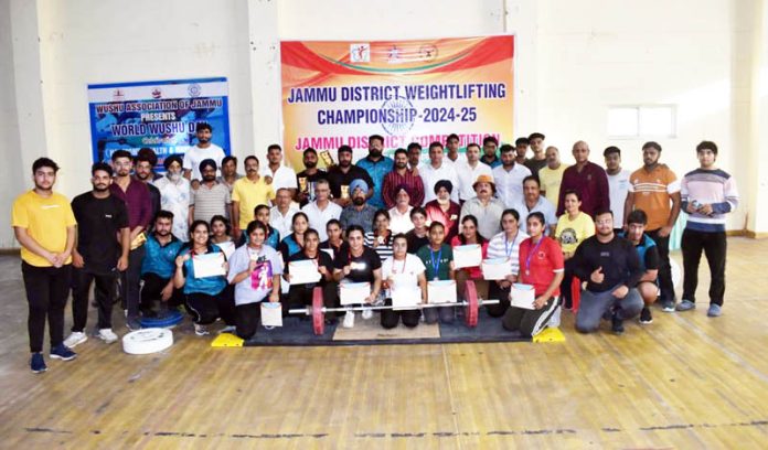 Weightlifters posing along with officials and dignitaries during district championship at Jammu.