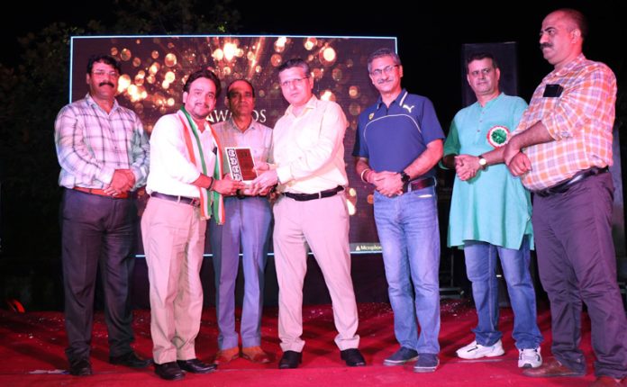 Relief and Rehabilitation Commissioner, Dr Arvind Karwani presenting awards to achievers in various fields at Jagti township during a function organised by LSEHO.