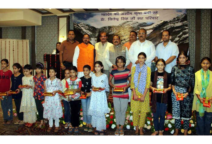 Children during a function organised by Shree Amarnath Ji Yatra Welfare Society with Rakshis in their hands posing with Union Minister, Dr Jitendra Singh and representatives of society at Jammu on Monday.— Excelsior/Rakesh