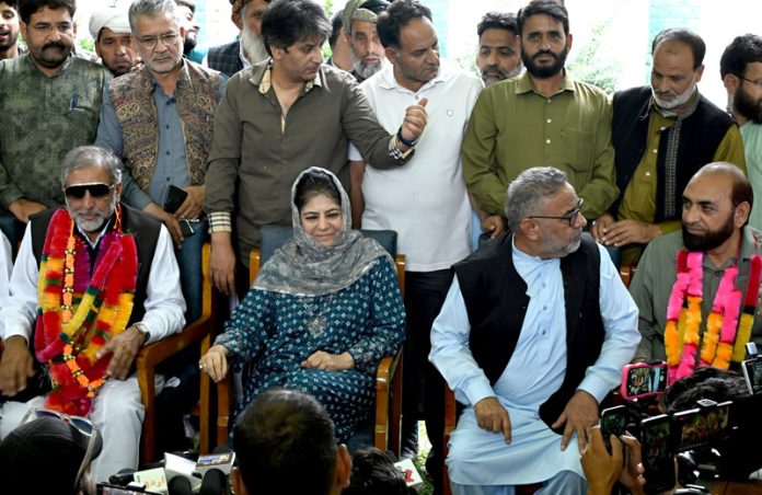 PDP President Mehbooba Mufti welcomes prominent Gujjar leader Qamar Choudhary and his supporters into the party fold in Srinagar on Wednesday. - Excelsior/Shakeel